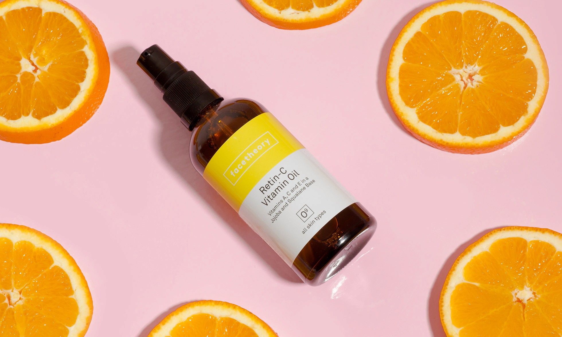 Facetheory skincare products: lemon slice and product lying on lemon fabric 2